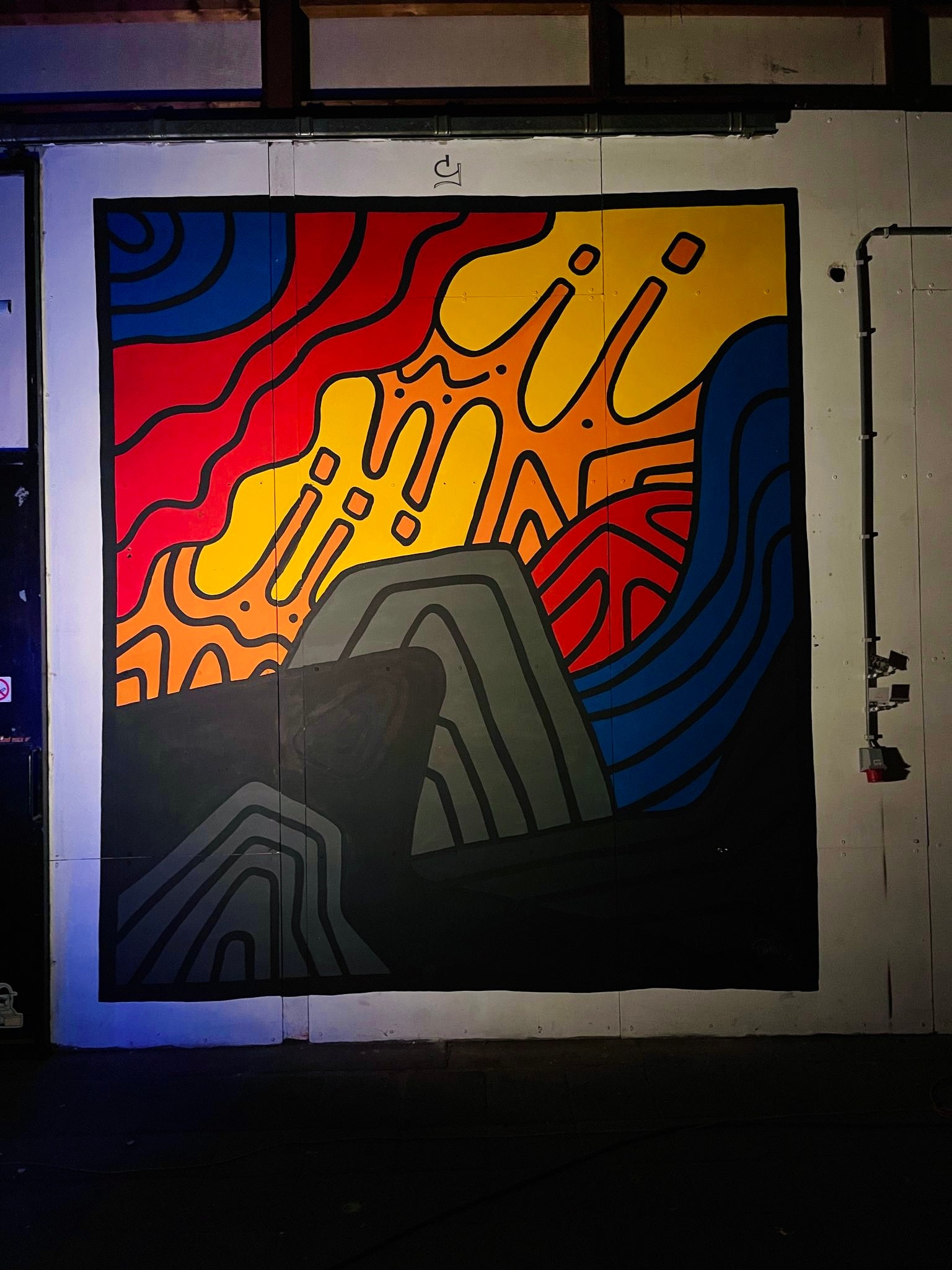 Colorful abstract mural on a wall with geometric shapes